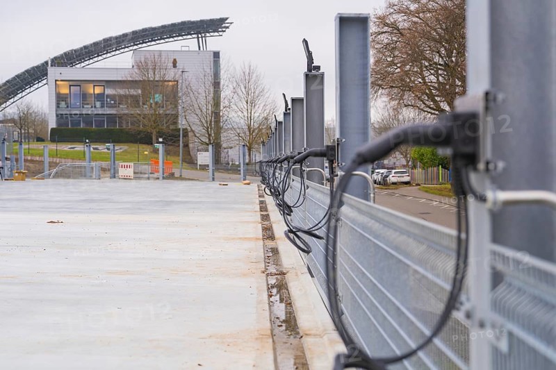 Row of charging stations with a modern building in the background, parking garage construction with charging infrastructure, Calw, Germany