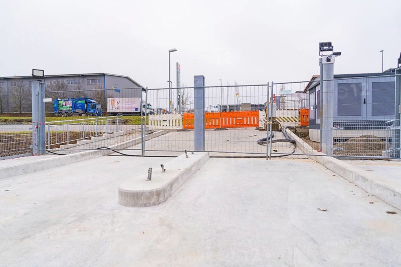 Closed construction site with concrete floor in an industrial environment, parking garage construction with charging infrastructure, Calw, Germany