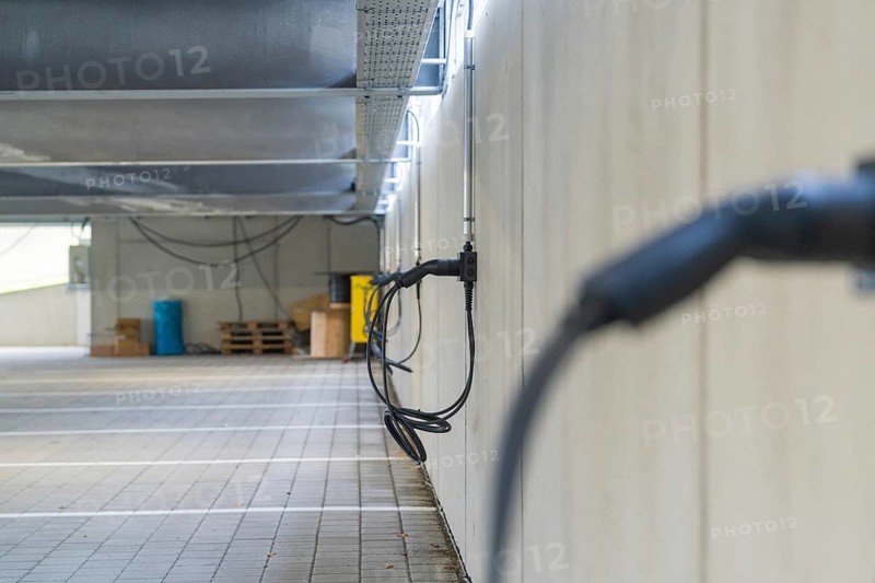 Electric charging cable on car park wall with concrete look, parking garage construction with charging infrastructure, Calw, Germany