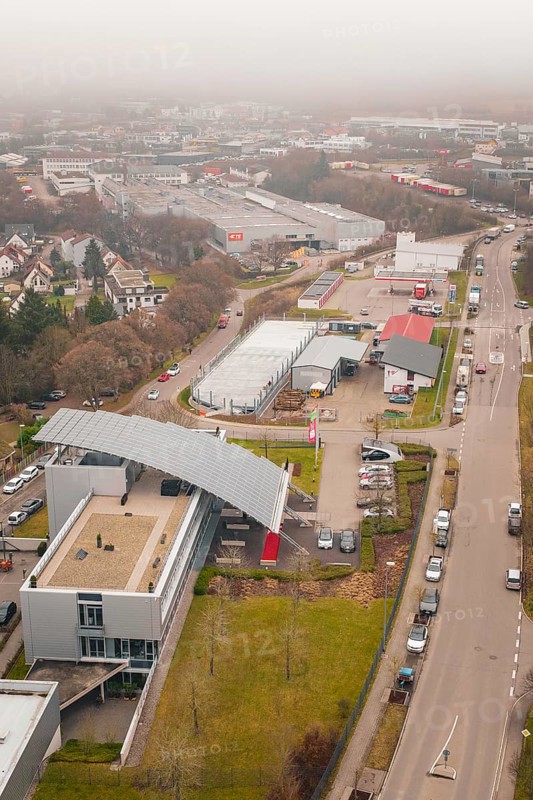 Further view of an industrial building within an urban landscape in winter, parking garage construction with charging infrastructure, Calw, Germany