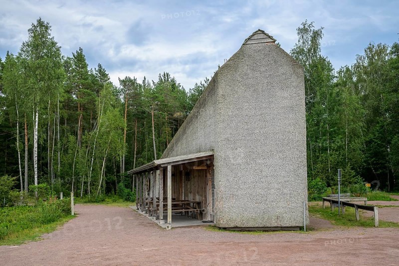 Naturum Nature Conservation Information Center at Vogelsee Tåkern, modern outbuilding with pitched roof and rest areas built entirely of reed thatch next to a large reed tree, Tåkern, Vadstena, Östergötalands Län, Sweden