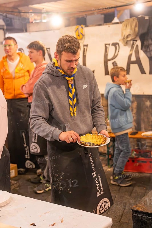 Person preparing waffles at a stand at a market at night, Weihnachtsmark Nagold, LandkreiScalw, Germany