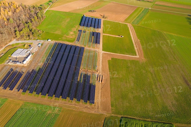 Extensive solar system in the midst of green and autumnal fields from the air, energy revolution, construction of PV open space, Baden-Württemberg, Germany