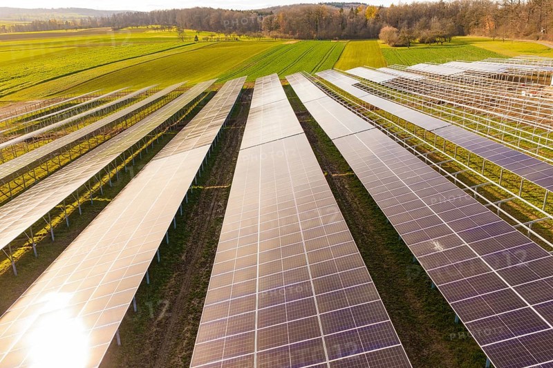 Consistent rows of solar panels on green land for energy generation, energy transition, construction of PV open space, Baden-Württemberg, Germany