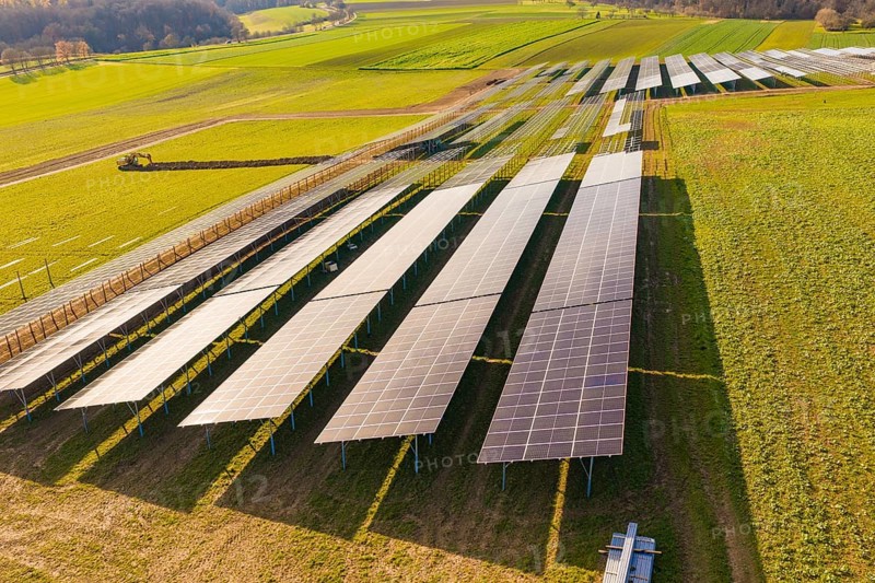 Aerial view of large solar systems on green fields in a rural landscape, energy transition, construction of PV open space, Baden-Württemberg, Germany
