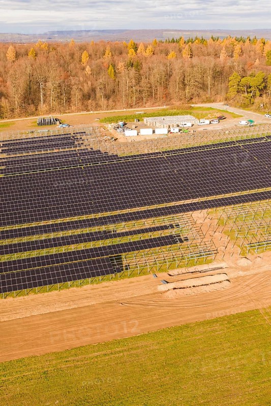 Large solar fields next to a forest area in autumn, energy revolution, construction of PV open space, Baden-Württemberg, Germany