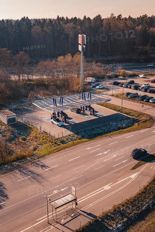 Charging station with electric car near a forest, quiet surroundings with sunset and autumn flair, ENBW charging park, Rutesheim, Germany