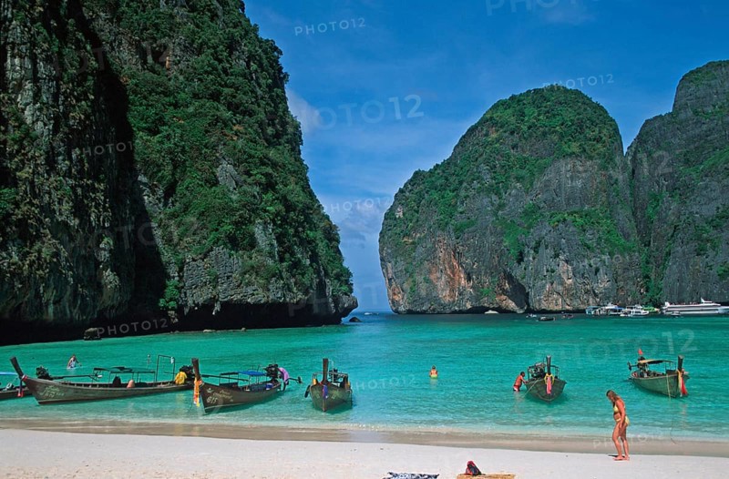 People, longtail boats on Maya Bay beach, known from the movie The Beach, one year in front of the tsunami, Ko Phi Phi Le, Thailand, December 2002, vintage, retro, old, historic