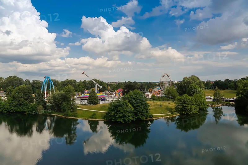 Fairground in Ulm Friedrichsau, folk festival, hustle and bustle, ferris wheel, amusement park, amusement attraction, ride, blue sky, clouds, natural lake, Ausee, Ferris wheel, Ulm, Baden-Württemberg, Germany