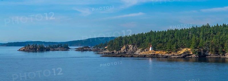 Passengers traveling by ferry from vancouver to victoria, british columbia, enjoying scenic views of rugged coastlines, lighthouses, and tranquil blue waters