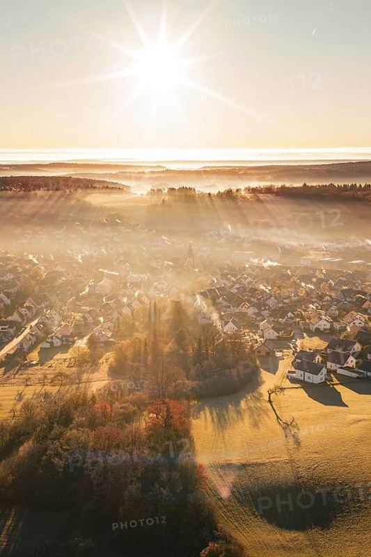 Sun-drenched settlement in fog with landscape view at sunrise, Gechingen, Calw district, Germany