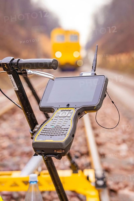 A technical device with a screen on a rail surveyor in the blur of the background, stuffing machine on Hermann, Hesse, Bahn, Althengstett, Calw district, Germany