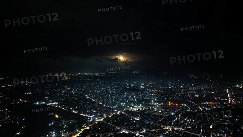 A Drone night view of Aleppo, Syria on December 19, 2025, showing illuminated streets, dense residential areas, and major traffic routes under the night sky, Aleppo, Aleppo, Syria