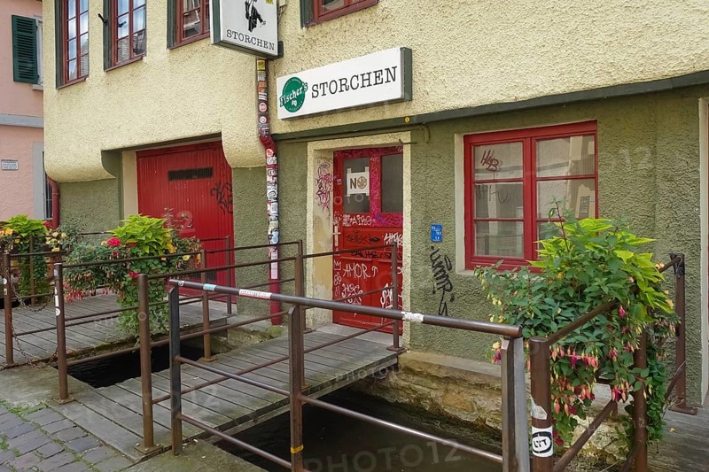 Pub, stork, traditional restaurant, beer pub on the river Ammer, red front door, graffiti, bridge, Tübingen, Baden-Württemberg, Germany