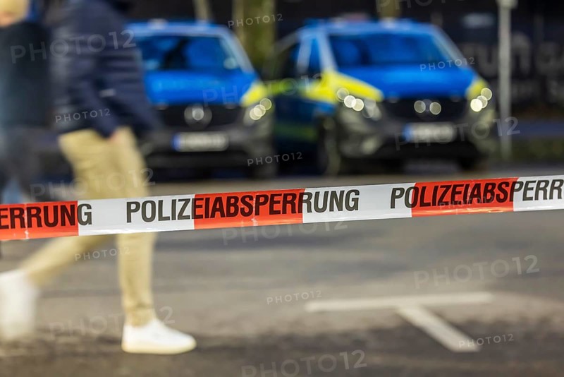 Flutter tape with the inscription police barrier. Behind them, police vehicles. Stuttgart, Baden-Württemberg, Germany