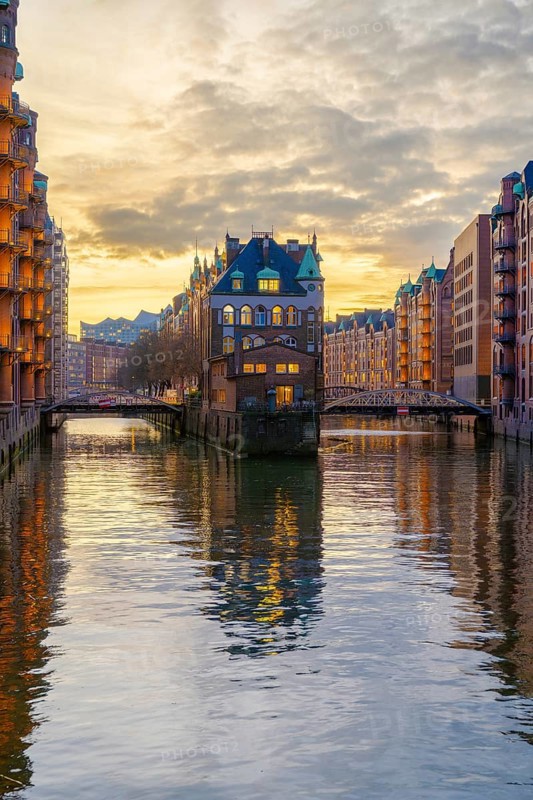 Water castle in the Speicherstadt Hamburg on a wall frame fleet with clouds in the background at golden hour, Hamburg, Germany