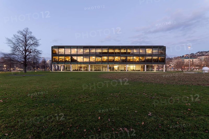 The state parliament of Stuttgart glows impressively in the evening. The architecture is accentuated by the night light and creates a clear, atmospheric atmosphere