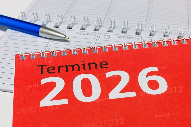 2026 calendar with red cover, blue pen and spiral binding, diary