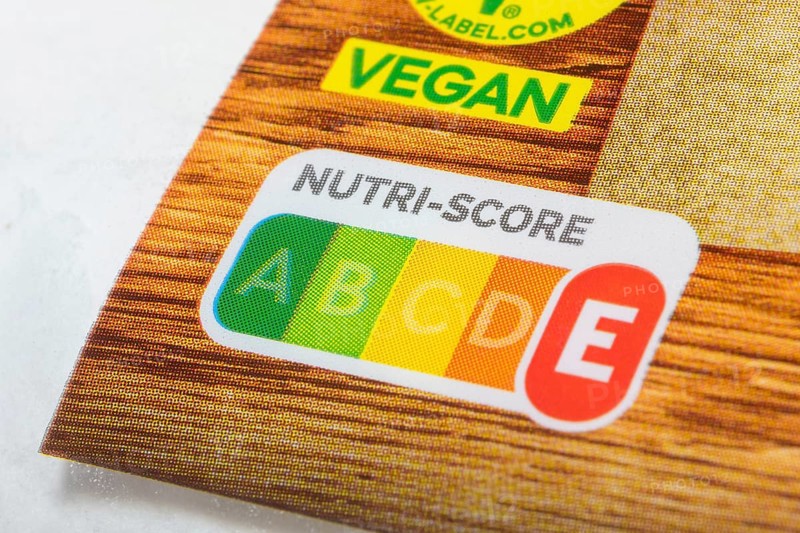 Food packaging with prominent Nutri-Score label and vegan sticker