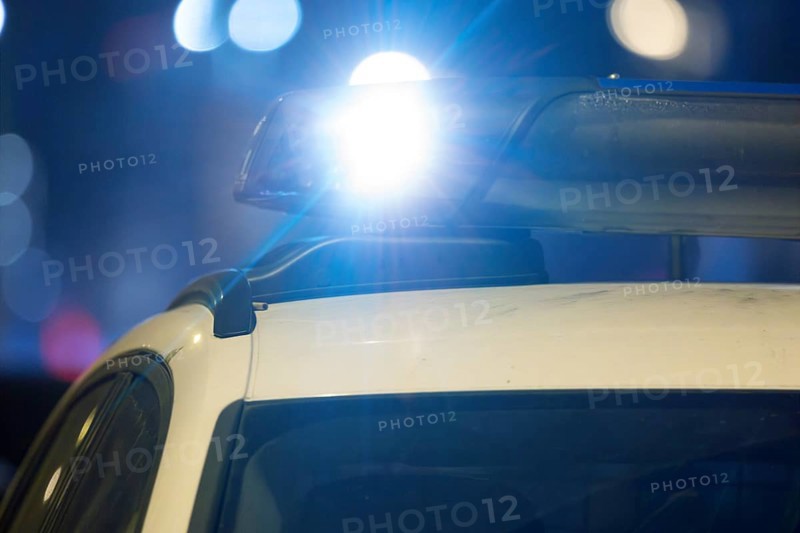 Symbolic image police operation: close-up of a blue light on a police car (digitally reworked)
