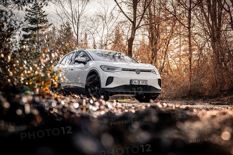 Car in an autumn forest landscape with bare trees, VW ID4 electric car, Deer Carsharing, Calw, Germany