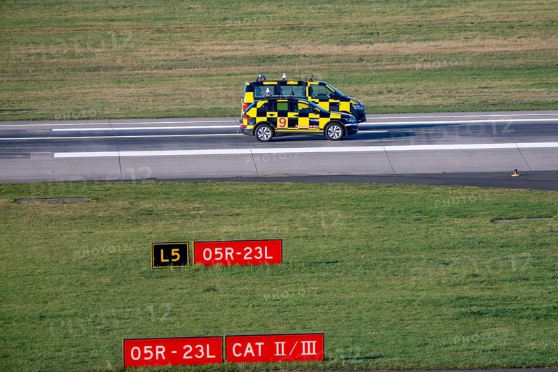 Inspection of runway 05R/23L 3000m main runway south, by Marshall vehicles also called Follow Me vehicle, pilot vehicle, apron supervision, directs aircraft to their parking position, at Düsseldorf Airport, DUS North Rhine-Westphalia, Germany