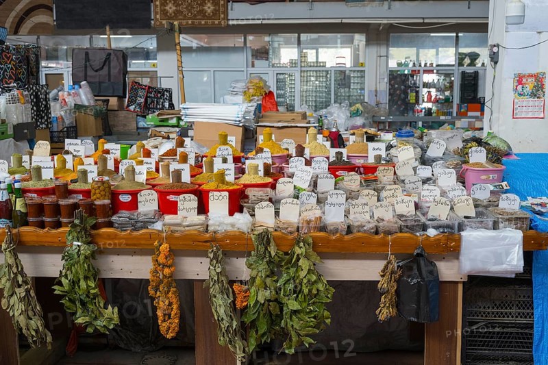 An extensive market stand with spices in red buckets and dried herbs, Akhaltsikhe market, Samtskhe-Javakheti region, Samtskhe-Javakheti, Georgia