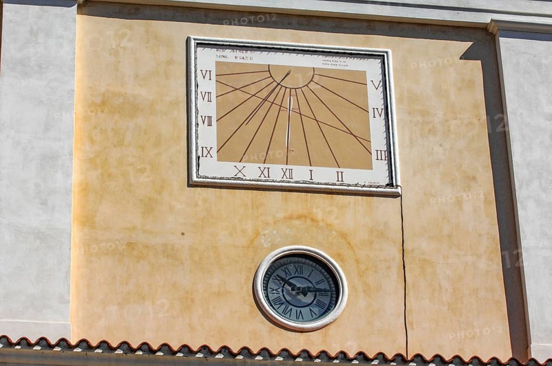 Sundial above and below masonry clock with hands, Italy