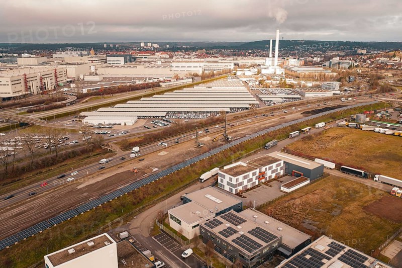 Industrial area with chimneys and factory buildings under a cloudy sky, A81, Böblingen, Germany