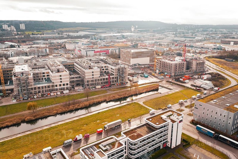 City view with modern buildings under construction along a small river in an urban area, Böblingen, Germany