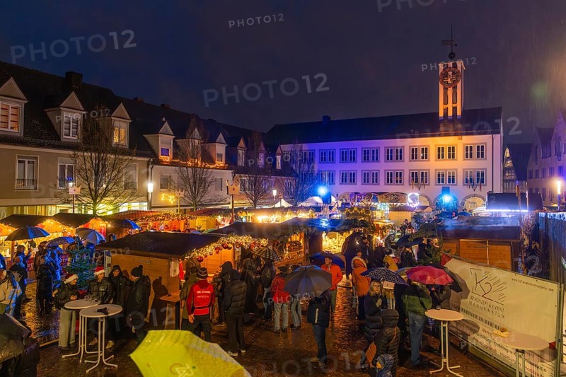 Busy Christmas market at night with bright lights and rainy atmosphere, Böblingen Christmas market, Germany