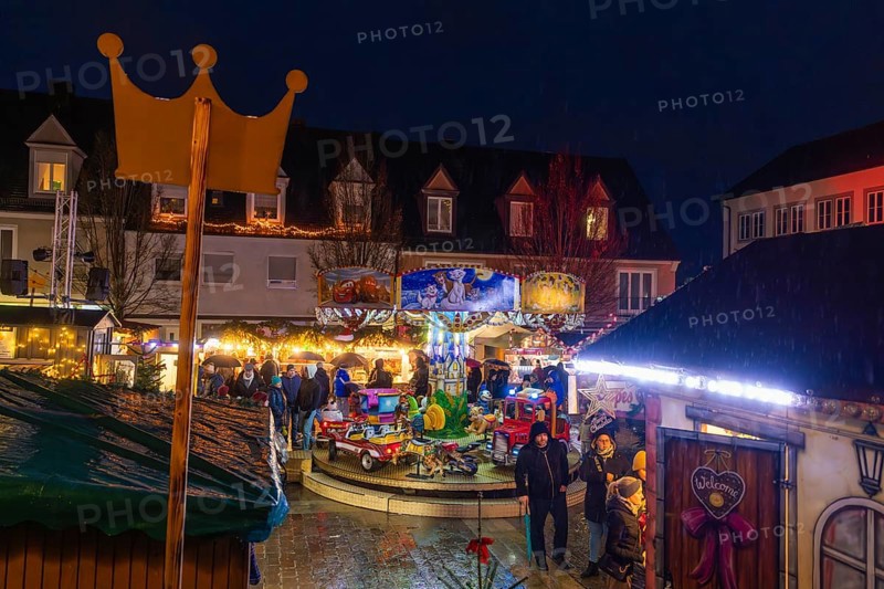 Overview of a Christmas market with crown, carousel and festive lighting at night, Böblingen Christmas market, Germany