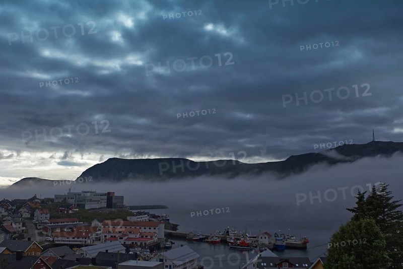 City scene in gloomy weather with fog over the water, Honningsvag
