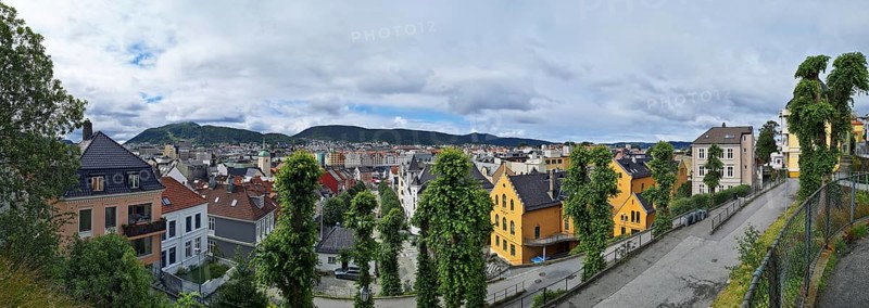 Panorama of the city of Bergen with yellow and white houses and lush greenery, Bergen Norway