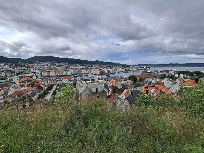 Panoramic view of Bergen city with hills in the background under a cloudy sky, Bergen Norway