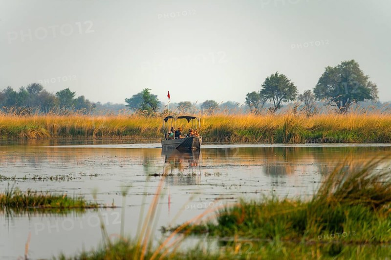 Tourist boat on safari in the lagoon, Xakanaxa Lagoon, Okavango Delta, Moremi Game Reserve, Botswana