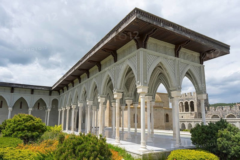 Historical building with decorated portico surrounded by green bushes and cloudy sky, Rabati Fortress, Akhaltsikhe, Samtskhe-Javakheti region, Samtskhe-Javakheti, Georgia