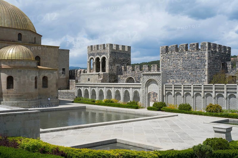 Stone building with golden dome, arcades and water basin in front of an imposing stone wall, Rabati Fortress, Akhaltsikhe, Samtskhe-Javakheti region, Samtskhe-Javakheti, Georgia