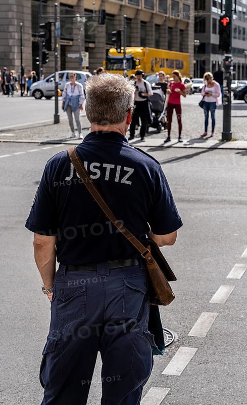 Judicial staff waiting at a pedestrian traffic light, Berlin, Germany