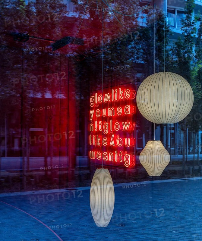 Ceiling lights, looking through the shop window into the interior of a furniture store, Berlin, Germany