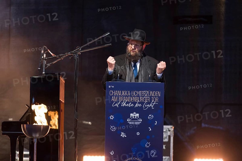 Yehuda Teichtal (Rabbi of the Chabad-Lubavitch movement) speaks at the lighting of lights to mark 20 years of Hanukkah in front of the Brandenburg Tor tor, Berlin, 17 December 2025