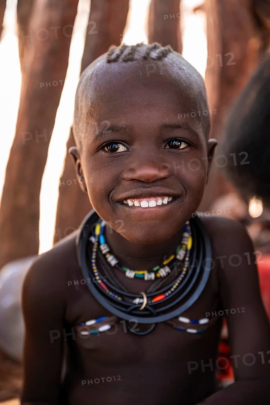 Portrait, grinning Himba child, traditional Himba village, Kaokoveld, Kunene, Namibia