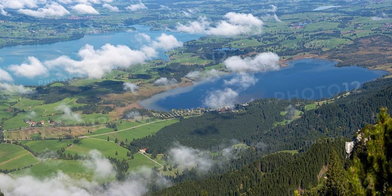 Panorama from Tegelberg, 1881m, of the cloud-covered Forggensee and Bannwaldsee, Ostallgäu, Bavaria, Germany