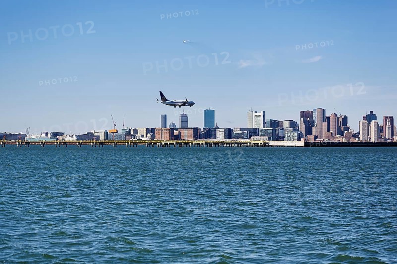 Boston skyline with an airplane landing at Logan International Airport, Boston, Massachusetts, New England, USA