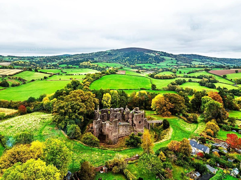 Autumn Colours over ruins of Grosmont Castle from a drone, Grosmont, Monmouthshire, Wales, UK