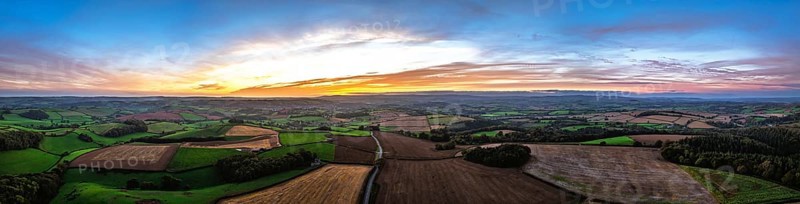 Sunset of Devon Farms and Fields over Berry Pomeroy from a drone, Totnes, England, United Kingdom