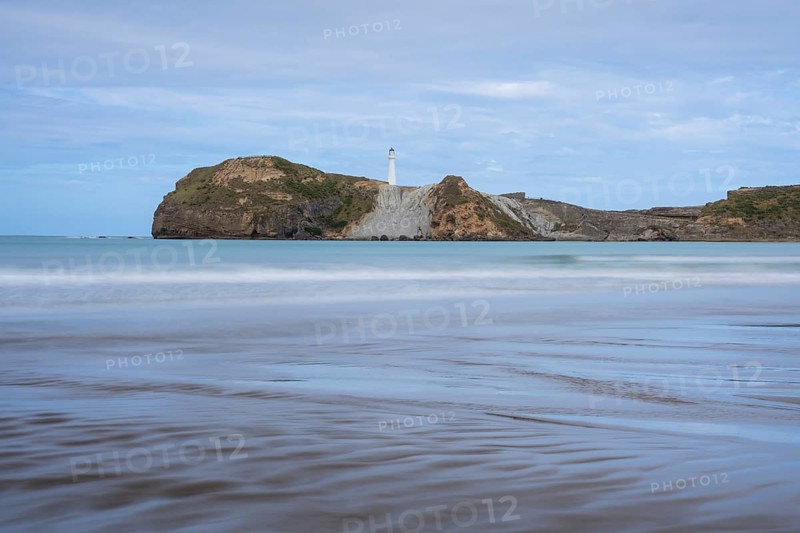 Castlepoint Beach, ocean and lighthouse on a rock, long exposure. Castlepoint, Wairarapa Coast, Wellington Region, North Island, New Zealand