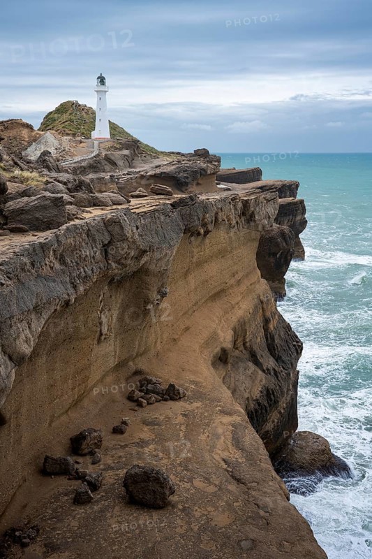 Castlepoint lighthouse on a rock, ocean. Castlepoint, Wairarapa Coast, Wellington Region, North Island, New Zealand