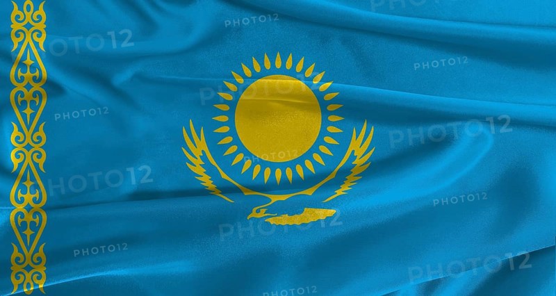 Flag of Kazakhstan with fabric textured background. Close up of National flag of Kazakhstan with realistic texture