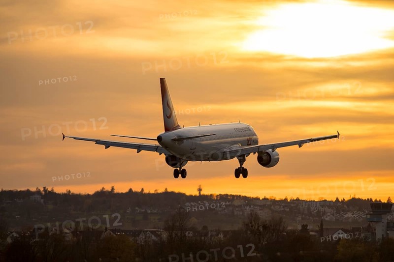 Airplane landing at sunset, orange light on horizon, Stuttgart airport, Leinfelden-Echterdingen, Baden-Württemberg, Germany